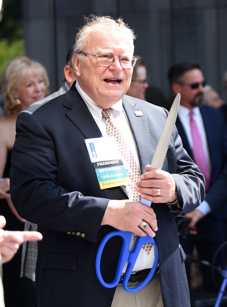 Bob Priddy boasts ceremonial scissors before the ribbon cutting
